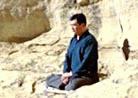 Published on 1/17/2000 Master Li quietly watching the world from amidst the mountains after leaving New York following July 20th, 1999
