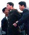 Published on 10/29/2000 Two plainclothes police arresting a Falun Gong practitioner in police uniform on Tiananmen Square