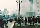 Published on 10/25/1999 Police sprays water on Falun Gong practitioners doing exercises in a group before the start of the suppression on July 20, 1999.