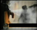 Published on 9/12/2001 Analysis of the "Tiananmen Self-immolation" video-Liu Chunling is facing the extinguisher. The fire on her body has already been put out. At this very moment, an outstretched arm reaching toward Liu Chunlings head is faintly visible. Liu is struck on the head.