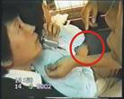 Published on 8/20/2002 Hong Kong Falun Gong practitioners file appeal based on police’s false accusations (Photos)--This policewoman withdrew her arm and pointed to the inside of her arm and shouted, "She bit me, she bit me!" This was not the part of the arm that was under Lu Jie’s chin. The magistrate said that the policewoman "definitely won’t be wrong" but she simply didn’t know where she was "bit." 
