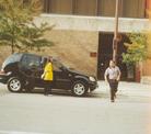 Published on 11/14/2002 Criminal who assaulted Falun Gong practitioners in front of the Chicago Chinese Consulate apprehended and admits guilt in court --Weng Yujun (left, in the car) pushing the car door open to get out.
