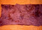 Published on 1/15/2001 In November, 2000, a practitioner  went to Beijing to appeal and he was eventually caught by the police and sent to the Detention Center in Miyun County. One day, he used a piece of cloth from the edge of the bathroom sink to wipe his hands, and then washed this piece of cloth clean. Upon taking a closer look, he saw that the cloth was the top part of a T-shirt. Its front was printed with the words "Falun Dafa", and its back printed with "Zhen-Shan-Ren". 
The T-shirt was torn apart, and the bloodstains on the top part were still clearly visible (see photo). It turns out that the T-shirt was worn by a practitioner who was detained here.  
