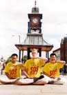 Published on 8/18/2001 Three Falun Gong practitioners in SOS T-shirts practice exercise five in Britain, August 2001.