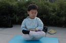 Published on 5/4/2001 Young Falun Dafa diciple sits in meditation outside a Metro entrance during morning practice, 2001.