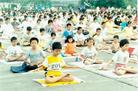 Published on 3/16/2004 Young Dafa diciples practice Exercise Five during large-scale group practice at Shenzhen City Stadium, China, 1998.
