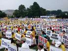 Published on 7/23/2003 Falun Gong representatives from all over the world with placards of their native countries and words such as "Stop the Persecution", "Urgently Rescue Charles Li", and "Bring Jiang Zemin to Justice".