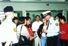 Practitioners with Tears in Their Eyes and Holding Photos of Fellow Practitioners Tortured to Death in China Clarify the Truth to Police Chief in June 2002