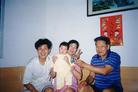 Published on 9/2/2002 Family photo of Mr. Chen Chengyong, a Falun Gong practitioner who was tortured to death in July 2001 at the age of 34, leaving behind young Fadu.
