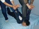 Published on 10/14/2004 Two prisoners press the practitioner on the floor and secure his feet. Then they pull his arms up and bend them backwards The practitioner can hardly breathe and his arms feel as if they are breaking off.

