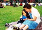 Published on 2000 Adult and child Falun Gong practitioners study together in a park in Canada.