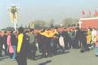 Published on 1/6/2002 A handicapped Falun Gong practitioner was taken away by plainclothed policeman after she unfurled a banner at Tiananmen Square.