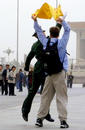 Published on 4/14/2002 A Western student from California displays a banner that reads "Falun Dafa is good" at Tiananmen Square; policeman grabs the banner away.