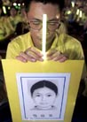 Published on 1/13/2001 A Falun Gong follower prays holding the portrait of a follower allegedly killed by the Chinese government, during a protest in Taipei July 20, 2001. The followers say more than 200 practitioners of the belief have died in police custody in China.