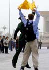 Published on 4/15/2002 BEIJING (AP) - A young man identified as an American university student was taken into custody peacefully Sunday after unfurling a banner on crowded Tiananmen Square and shouting [statements] supporting the outlawed Falun Gong [group]. 


The man, identified by Falun Gong supporters in the United States as Andrew Muir Ellsmore, 21, was quickly driven off in a police van that had been stationed nearby -- standard operating procedure in the public square that represents the heart of Chinese communism.