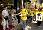 Published on 8/13/2001 Photo Collection: Media Report on Falun Gong March in Hong Kong. 20 members of the meditation [group] marched down a Hong Kong street on Friday, Aug. 10, 2001. The Falun Gong protesters marched in support of Lau Yuk-ling, right, a Hong Kong resident and Falun Gong practitioner, who’s son Chan Yok-to, on a poster, also a Falun Gong follower, was arrested in Beijing on July 12, 2001 on the last day of a three-day campaign demanding Chan’s release and calling on the Chinese government to stop persecuting [group] members. (AP Photo/Anat Givon)


