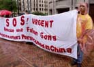 Published on 8/25/2001 Media Report on Seattle SOS Event. John Zheng of Seattle holds a protest sign before accompanying about a dozen other Falun Gong supporters at the start of their protest march from Seattle, Washington to San Francisco, California on August 22, 2001. The protestors are walking 900 miles in 50 days to bring attention to the political imprisonment of U.S. resident Dr. Teng Chunyan who is sentenced to three years in a Chinese prison after she protested in China the crackdown of Falun Gong practitioners by the Chinese government. Prior to her arrest, Teng operated a clinic in New York City. REUTERS/Anthony P. Bolante


