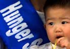 Published on 8/28/2001 Reuters Photo collection: Media Reports on DC Hunger Strike. Alice Tang celebrates her first birthday on her mother’s lap who is taking part in a hunger strike outside the Chinese Embassy in Washington, August 24, 2001. 10 members of the religious group, including April Zhang, the child’s mother, have been fasting for one week to protest the Chinese government’s stance towards members of the Falun Gong in China. REUTERS/Win McNamee


