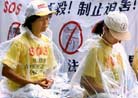 Published on 8/29/2001 Reuters’s Photo Report: HK Falun Gong in Fourth Day of Hunger Strike. Practitioners begin the fourth day of a hunger strike outside the Chinese Liason Office in Hong Kong August 28, 2001 to protest against the imprisonment of followers in mainland China.
