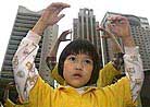 Published on 4/25/2001 A young Falun Gong follower practiced the exercises along with dozens of other practitioners in Hong Kong on Wednesday, April 25, 2001. 