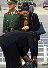 Published on 4/25/2001 A policeman checked a woman’s bag on the Tiananmen Square.