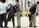 Published on 4/25/2001 Photo Report From Western Media On April 25, 2001. Falun Gong members detained on protest anniversary - Chinese plainclothes police detain a Falun Gong protester and confiscate his banner in Tiananmen Square in Beijing on April 25.
