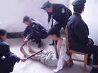 Published on 10/1/2004 		山东王村劳教所迫害法轮功学员酷刑图示（部分）---将大法学员铐在椅子上，４、５名警察用电棍电。