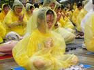 台中学员风雨中悼“7・20” 呼吁共同制止迫害   图为雨中发正念