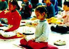 Young Falun Dafa practitioner sits in meditation.