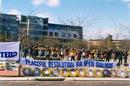 Practitioners practice the exercise behind the picture shows outside the Chinese Embassy in Canberra, Aug. 23, 2000