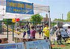 Published on 5/19/2001 Teaching Dafa excercises in front of the display boards.